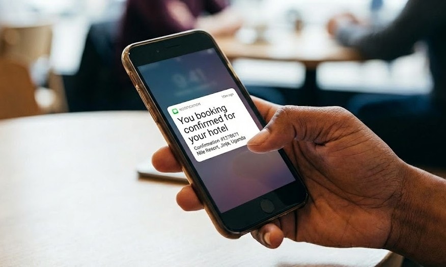 Hotel guest completing booking reservation on mobile device